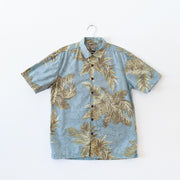 Retreat Short Sleeve Button-up Hawaiian Shirt. Light Teal Tropical Print Yellow and Green Pineapples. Brown Wood Buttons.