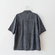Back of Charcoal grey button-up tropical print silk t-shirt with collar. 