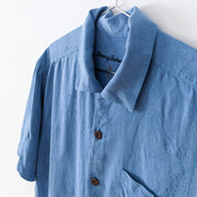 Tommy Bahamas Blue Silk Button-up Hawaiian Short Sleeve Shirt. Men’s Medium. Brown Buttons, Collar, Chest Pocket. Close-up.