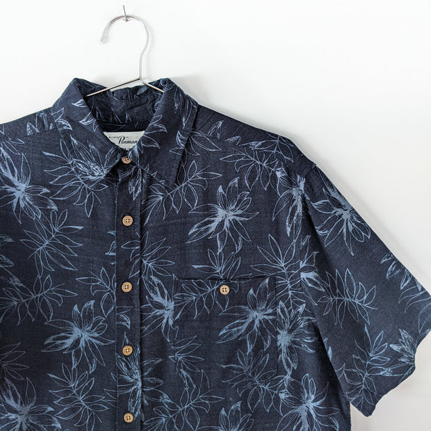 Bamboo Rayon/Cotton Button-up Short Sleeve Hawaiian Shirt. Black with Blue Leaf Print, Light Brown Buttons. Close-up.