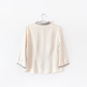 Back of vintage Lex-i-con Womens Button-up ¾ Sleeve Shirt. Cream with Black Embroidery at Collar.