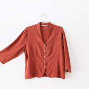 Hemp/Tencel Button-up V-Neck Shirt in Rust Orange. TSD Two Star Dog, ¾ Sleeve, Mother of Pearl Buttons, Arm Extended.