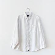 White linen button-down long sleeved collared shirt with two chest pockets that button.