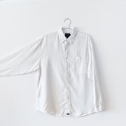 White linen button-down shirt with sleeve extended to show sleee width.