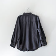 Back of Black linen button-up long sleeve shirt with collar, shoulder straps, and roll-up sleeves that loop.