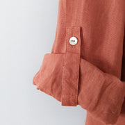 Close up Rolled-up Sleeve with Tab and Mother of Pearl Button. Linen Fabric on Light/Rusty Orange Conrad C Collection Shirt.