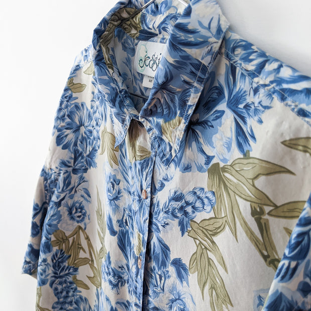 Vintage Jessie Blue Floral Button-up Long Sleeve Shirt. Close-up: Blue Flowers, Green Leaves, Off-White Background. Collar.