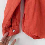 Close up of Cuffs, Mother of Pearl Buttons and Linen Fabric on Button-up Long Sleeve Shirt, Bright Rosy Orange. Ruby Rosa 8.