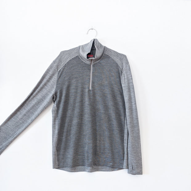 Icebreaker Grey Mock Neck Sweater. Half-Zip Neckline, Horizontal Thin Black Stripes on Torso. Merino Wool, Men’s Large. Arm Extended.