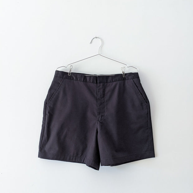 Black cotton shorts with pockets.