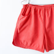 Vintage 90's Magic Mountain Shorts in Bright Red-Orange, Women’s Large 100% Preshrunk Cotton. Close up of Curved Side Hem.