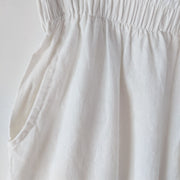 Close-up of elastic waistband and pocket on off-White high-waist wide-leg crop pants. Likely made from linen or cotton. Secondhand natural fiber clothing from Fold and Fray.