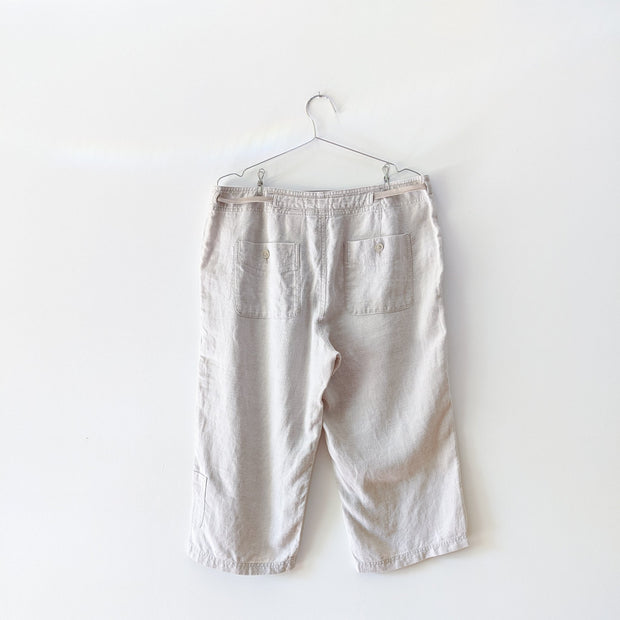 White Sand (an off-white beige) linen cropped pants with back pockets that button closed.