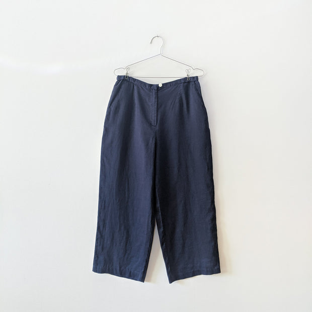 Navy ramie lightweight cropped pant with angled front pockets and cream button closure.