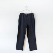Black vintage vertical-ribbed stretch cotton-knit pants with straight leg, narrow elastic waistband and side slash pockets. Jones New York. Secondhand from Fold and Fray.
