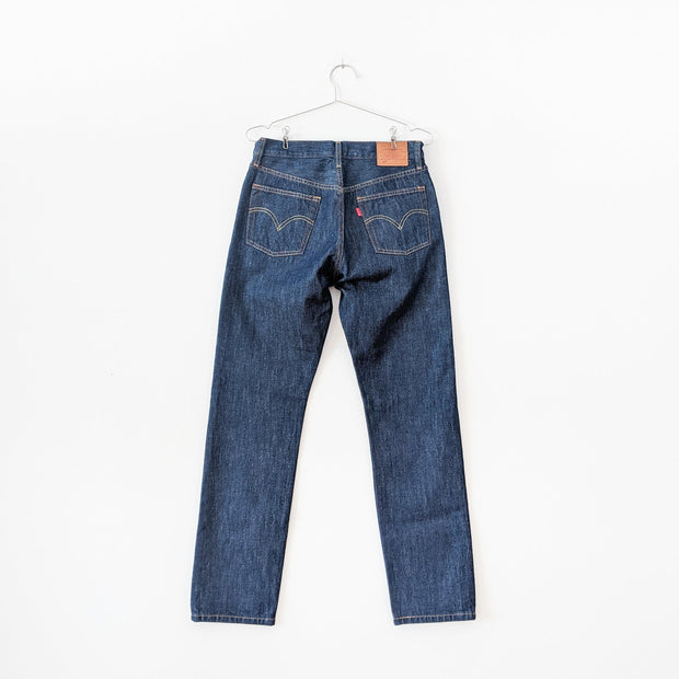 Levi's 501 Original Fit Dark Wash “Across A Plain” High-rise Blue Jean. Women's 28X30, Tapered Leg. Back of Jeans, Red Tag.