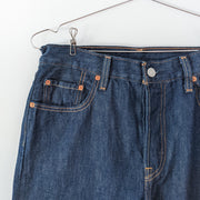 Levi's 501 Original Fit Dark Wash “Across A Plain” High-rise Blue Jean. Women's 28X30. Front Close-up Gold Stitching Bronze Rivets. 