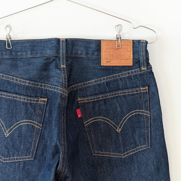 Levi's 501 Original Fit Dark Wash “Across A Plain” High-rise Blue Jean. Women's 28X30. Back Pocket Close-up Red Tag.