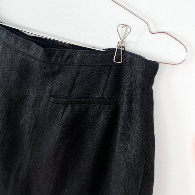 Back of Skirt. Welt Pocket, Narrow Waistband, Black Linen Fabric on Vintage Hechter Basics Black Linen Wrap Skirt.