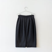 Vintage wool midi pencil skirt in Black, high-rise with a slit on the back.