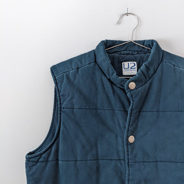 Dark Teal Quilted Vintage Cotton Puffer Vest. U2 Clothing, Size Large. Closeupof Shoulder. Fold and Fray.