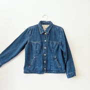 Cotton button-up denim jacket in Indigo Blue with collar, showing the arm extended.