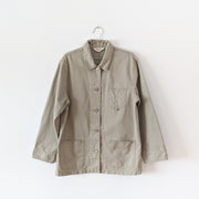 Cotton, field-style, barn jacket, chore coat in Sand Beige (like a greige, tan). Straight fit coat with three front patch pockets, metal buttons, a collar and detailed tapered sleeve cuffs. Eddie Bauer Women's. Secondhand, from Fold and Fray.