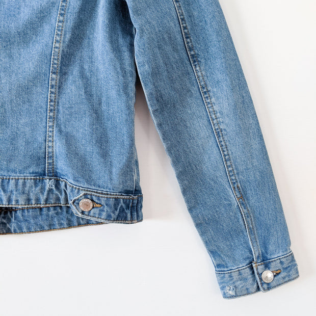 Light Blue Distressed Denim Jacket. Zara Authentic Denim by TRF Jean Jacket. Close-up of Cuff and Tab at Back with Button.