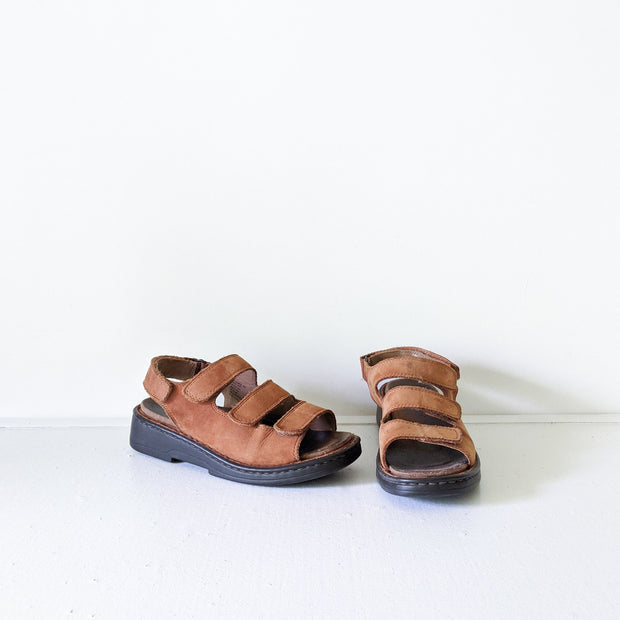 Deer Stags Brown Leather Slingback Sandals. Three Front Straps, One Back Strap, Black Sole. Front View.