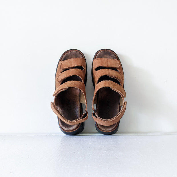 Deer Stags Brown Leather Slingback Sandals. Three Front Straps (Velcro), One Back Strap, Black Sole. Side View, One Sandal.