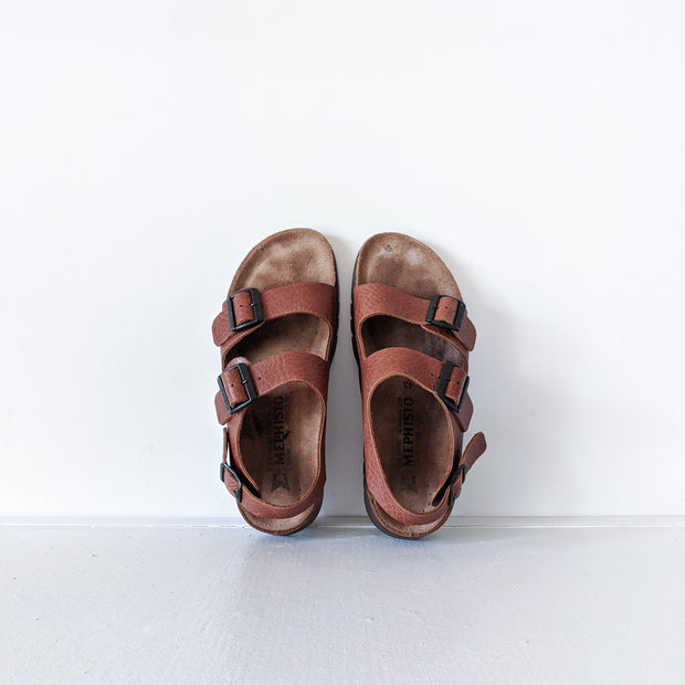 Top view, looking down, on Chestnut Brown leather Mephisto sandals with two front straps and one back strap, cork base.