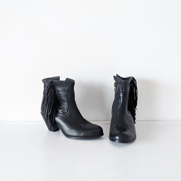 Black leather heeled ankle booties with: almond toe, interior side zipper, and western-style fringe. The top of the boot can be styled to roll down. Sam Edelman Black Louie Boot 8M. Secondhand from Fold and Fray.