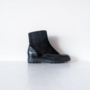 Outer side view of Black suede leather Chelsea-style boots with almond toe and heel covered with shiny wingtip patent leather. They have a low-platform sole, and stretchy hidden side panels. Barbara Barbieri, 40/10, Made in Italy. Secondhand from Fold and Fray.