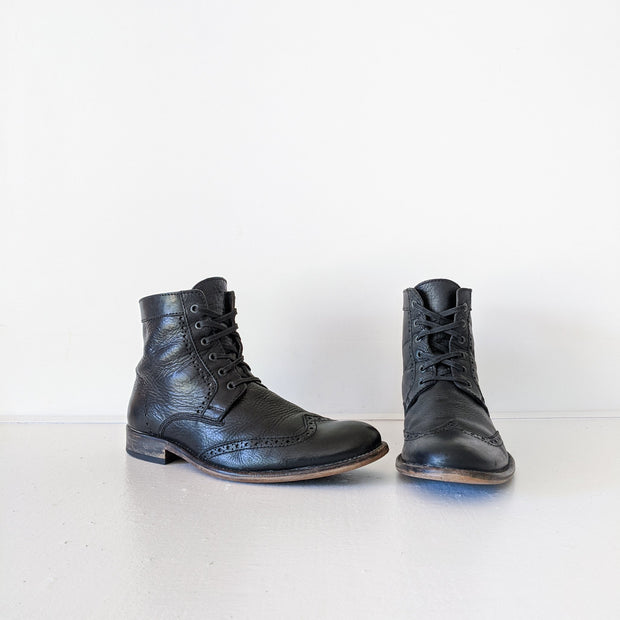 Black matte leather wingtip lace-up oxford boots. Above-the-ankle.