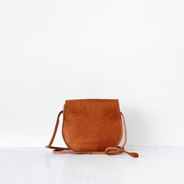 Back of Small Tan Leather Vintage Saddle Bag, Leather Vintage Purse with Flap. Golden Brown Leather Cross-body Bag.