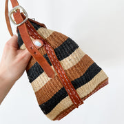 Close up of Brown, Black, Natural Jute/Woven Stripes and Reddish Brown Leather Adjustable Strap on Vintage Purse/Bag.