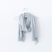 Pale Seafoam Green Scarf with Tassels, Looped over a Stainless Steel Hanger. Natural Fibre Clothing in Canada. Fold and Fray