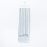 Pale Seafoam Green Scarf with Tassels, Folded over a Stainless Steel Hanger. Natural Fibre Clothing in Canada. Fold and Fray