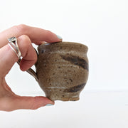 Small Handmade Brown Ceramic Pottery Mug. Vintage and Secondhand, Uneven Base. Guelph, Ontario, Canada.