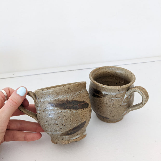 Two Small Brown Hanmade Ceramic Mugs. Mid-Tone Brown with White Marks and Dark Brown Brush Marks, Speckled.